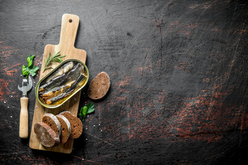 Sprats with slices of bread on the cutting Board.