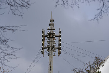 Power line pole with cables at City of Zürich on a blue cloudy autumn day. Photo taken December...