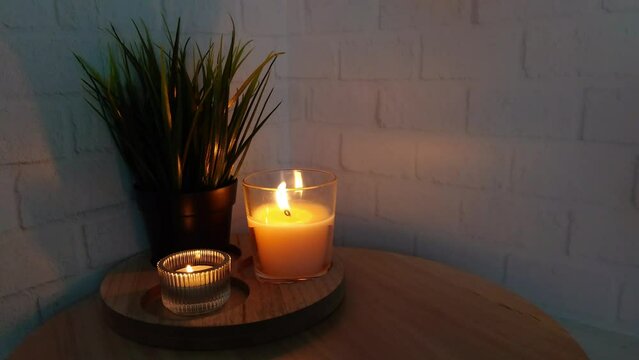 Burning candles in the dark on a wooden podium