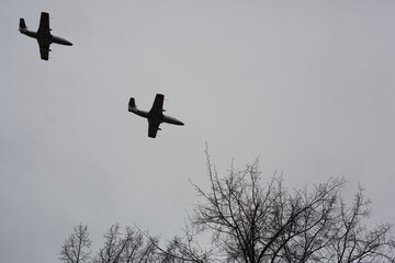 Military planes are flying over the city.