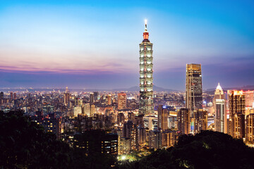 Fototapeta na wymiar View from above, stunning aerial view of the Taipei City skyline illuminated at sunset. Panoramic view from the Mount Elephant in Taipei, Taiwan.