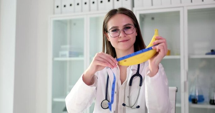Doctor woman holding banana in hand with measuring tape