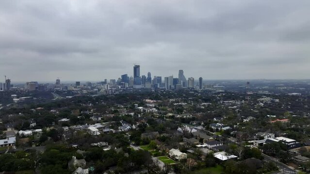 Aerial view approaching the Austin city skyline, gloomy autumn day in Texas, USA
