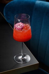 Glass of red alcohol cocktail on the table in a bar
