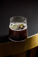 Glass of iced alcohol cocktail on the table in a bar