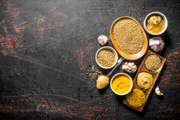Assortment of different types of mustard with garlic. - 562929870
