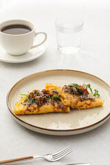 Portion of gourmet omelette with mushrooms and cheese