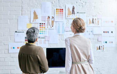 Fashion, designer teamwork and back of women in workshop looking at designs on wall. Collaboration, small business and senior female tailors in boutique planning and discussing color choice or sketch