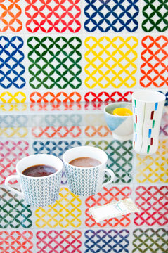 Mugs of coffee, colorful graphic background