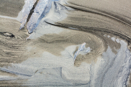 Patterns caused by sediment transport by water in the sand on Bunes Beach, Moskenesoya, Lofoten Islands, Norway.