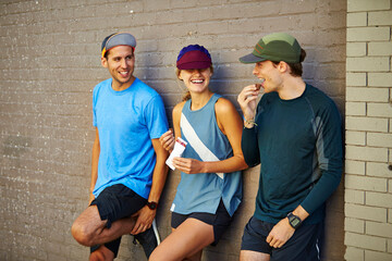 Three athletes hanging out and snacking