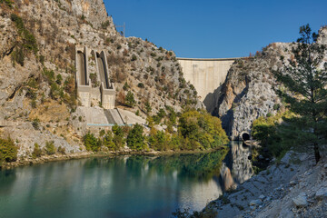 Dam lake in Green Canyon. Beatiful View to Taurus Mountains and turquoise water. Coniferous forest with green pine trees and a road stretching into the distance. Manavgat, Turkey.