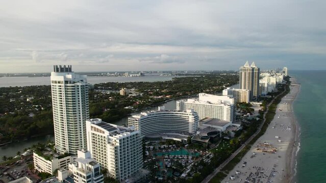 Miami Beach in the evening, drone shot of the beachfront with hotels and resorts.