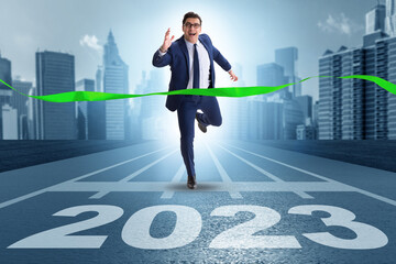 Businessman running to new 2023 year