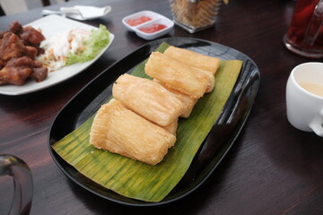 Delicious crispy golden brown fried cassava on top of black plate