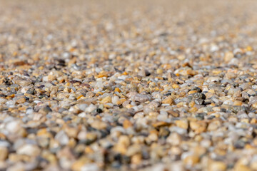 Fototapeta na wymiar Small multicolored pebbles, road rubble, selective focus.