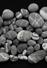 Fototapeta na wymiar Variety Gray Pebbles With White Quartz Veins Inside Vertical Photo For Backgrounds 