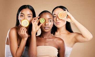 Skincare, diversity and women with fruit, cosmetics and dermatology with friends on brown studio...