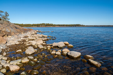 Fototapeta na wymiar View of the rocky shore of Hogholmen and sea, Hanko, Finland