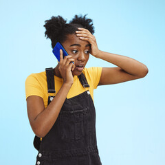 Shocked, surprised and black woman on a phone call for news isolated on a blue background in...