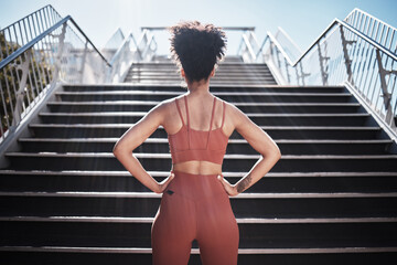 Fitness, woman and stairs for sport in city for running, exercise or healthy cardio preparation. Back of African American female ready for training, workout or sports run for wellness by staircase