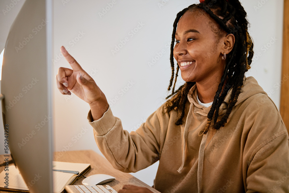 Poster computer, education and research with a student black woman pointing at her screen while learning at