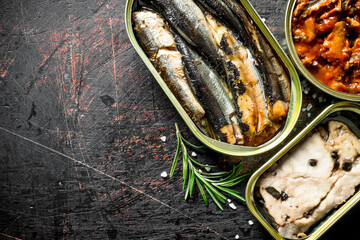 Canned fish in tin cans of rosemary.