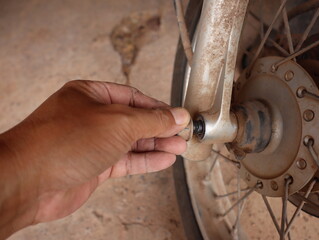 motorcycle mechanic remove the front wheel nut of motorcycles