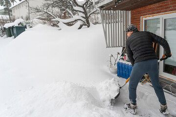 Man removing snow from the yard after snowstorm.