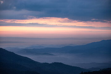 Fototapeta premium An image landscape forest layer mountain and fog or mist in the travel day vacation in the tourist in start the day winter atmosphere background.