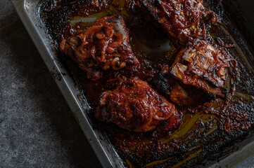 Barbecue pork with thick ribs glazed with barbecue sauce and onions. Served on a baking sheet...