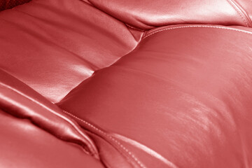 Modern luxury car red leather interior. Part of red leather car seat details with stitching....
