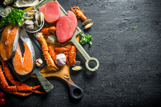 Tuna and salmon steaks on cutting boards.