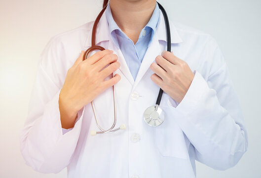 Crop image of professional confident young female asian doctor in white coat, stethoscope over neck