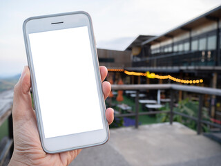Hipster girl holding phone in her hand at outside of cafe, selective focus.