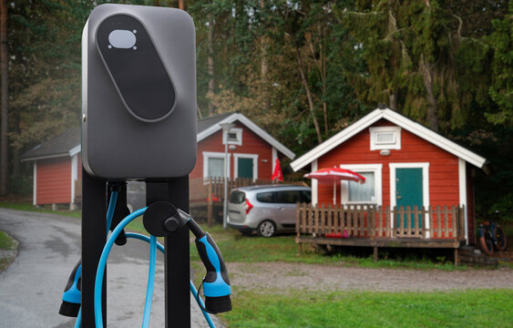 Close-up of a charging station for electric car against the backdrop of a campsite