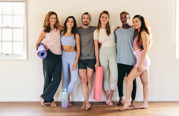 Fototapeta na wymiar Fitness friends standing against a wall in a yoga studio