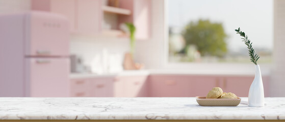 White marble kitchen tabletop with empty space over blurred beautiful pastel pink kitchen room