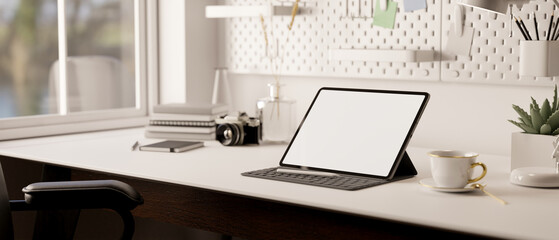 Portable tablet with wireless keyboard is on modern minimal white table. minimal workspace