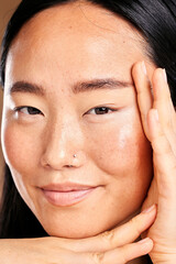 Closeup portrait, hand frame and asian woman in studio with skincare, natural skin glow and smile....
