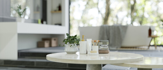 Luxury white marble tabletop with bath accessories over blurred background of luxury bathroom