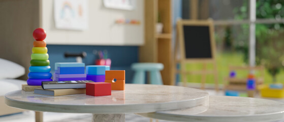 Kid toys on tabletop over blurred background of colorful kindergarten classroom or kids playroom