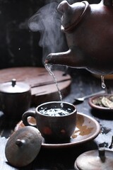 Tea is an aromatic beverage prepared by pouring hot or boiling water over cured or fresh leaves of...