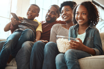 Black family watching tv on sofa for movie, film and cartoon together, bonding and quality time in living room. Popcorn, kids television show of people, mother and father with kids, on couch watching
