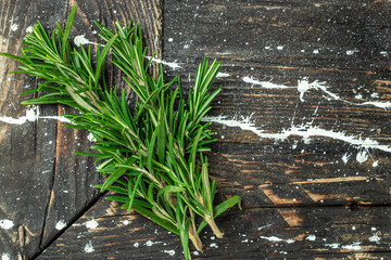 Fresh rosemary herb on a wooden background, banner, menu, recipe place for text, top view