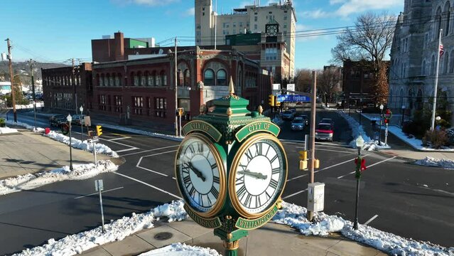 Slow aerial rising shot of City of Williamsport clock on snowy day in December.