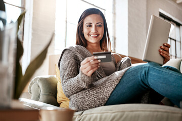 Online payment, digital tablet and credit card by woman on a sofa for online shopping in her home....