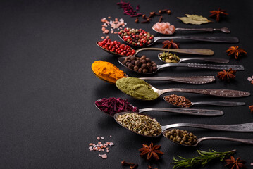 Composition consisting of variations of spices in white bowls and metal spoons