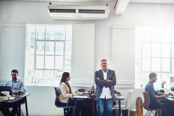 Man, leader and office portrait with staff, happy and confident smile with arms crossed for success. Senior manager, leadership and focus for corporate teamwork, group cooperation or marketing vision