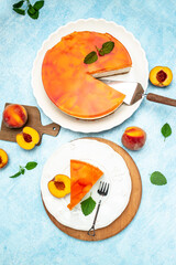 Tasty cheesecake with fruit peaches, peache jelly, jam on a blue background. vertical image. top view. place for text